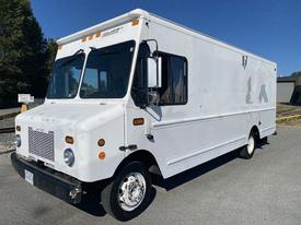 A white 2006 Workhorse W42 box truck with large windows and a flat front featuring multiple amber lights on the roof and a vent on the side