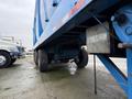 A blue 2011 Freightliner Cascadia Nordic truck with visible wheels and undercarriage components