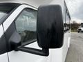 A 2017 Chevrolet Express side mirror with water droplets on it