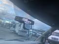 A 2017 Chevrolet Express van viewed from the inside with a rearview mirror reflecting a trailer being towed behind it