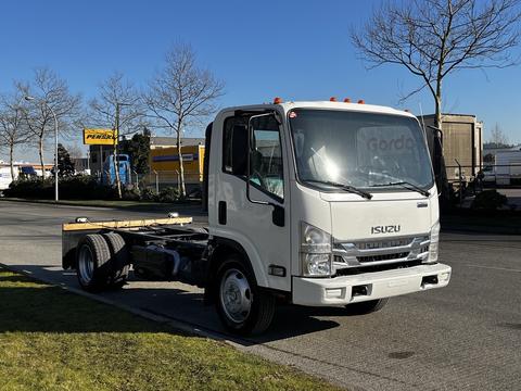 A 2017 Isuzu NQR truck with a white cab and chassis design parked on a street