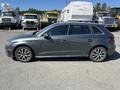 A 2016 Audi A3 hatchback in gray color with sporty alloy wheels parked on a lot