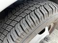 Close-up of a tire from a 2015 Chevrolet Express showing a tread pattern with visible wear and grooves