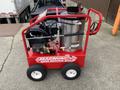 2024 Magnum 4000 Hot Water Pressure Washer on a wheeled cart with a red frame a large silver tank and various hoses and attachments visibly mounted