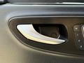 Close-up of the door handle of a 2019 Mercedes-Benz Sprinter showcasing a sleek chrome design and black interior material