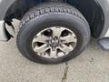 A close-up of a 2014 Ford F-150 tire and rim showcasing the Nexen Rotivar tire tread details and the alloy wheel design