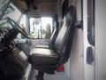 2003 Freightliner MT45 Chassis with two black leather seats positioned in the driver's area