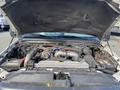 Engine bay of a 2003 Ford F-450 SD showing various components including the engine air intake and wiring harnesses