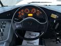 A close-up of the steering wheel and dashboard of a 2016 International 4200 with multiple gauges and controls illuminated