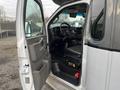 Interior view of a 2017 Chevrolet Express with the driver's seat visible and dashboard features shown including controls and storage compartments