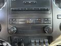 Interior dashboard controls of a 2016 Ford F-350 SD featuring climate control knobs audio system buttons and auxiliary switches