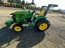 A green and yellow 2019 John Deere 3046R tractor with a yellow seat and large tires is positioned in profile view