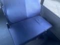 A blue seat from a 2017 Chevrolet Express with a slightly worn surface and visible fabric texture