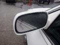 Side mirror of a 2008 Cadillac Limousine with water droplets on the glass