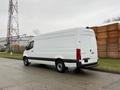A white 2019 Mercedes-Benz Sprinter van with a high roof and sliding side door parked on a concrete surface