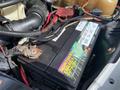 A close-up view of a car battery labeled Northern Energy Batteries with visible cables and connections in an engine compartment