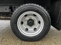 A close-up of a silver alloy wheel with a Michelin tire showcasing the tread pattern and hub details