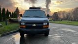 A 2005 Chevrolet Express van facing forward with a black grille and the iconic Chevrolet emblem in the center