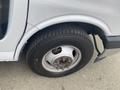 Close-up of a tire on a 2018 Chevrolet Express showcasing the tread and hubcap design with visible lug nuts