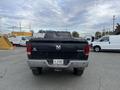 A black 2010 Dodge Ram truck viewed from the rear with the tailgate down and a visible license plate