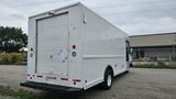 A white 2006 Ford Econoline van with a cargo-style rear door and no windows on the back