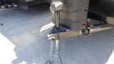 A 2022 Aspen Trail travel trailer hitch with a front stabilizer jack and a power tongue jack attached