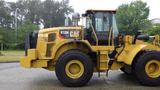 A 2019 Caterpillar 972M XE loader with a yellow exterior and large tires, featuring a spacious operator cabin and prominent CAT branding on the side