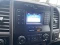 Dashboard of a 2021 Ford F-550 showing the media display with radio station and song title visible