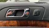 The interior door handle of a 2013 Lincoln MKT with a chrome finish and a control panel featuring lock and unlock buttons