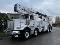 A white 2011 Western Star Trucks 4900 with an elevated utility platform and hydraulic arms designed for maintenance and construction work