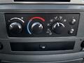 Control panel of a 2008 Dodge Ram 5500 featuring climate control knobs and air vent settings