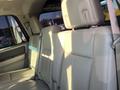 Interior of a 2013 Ford Expedition showing two rows of leather seats with headrests and seatbelts