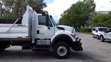 2014 International 7500 truck with a white dump bed and side exhaust visible parked on pavement