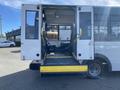 A 2017 Chevrolet Express with an open rear door and a yellow wheelchair lift extended from the back entrance