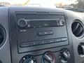 The dashboard of a 2008 Ford F-150 XL featuring a radio display and control knobs for volume and tuning