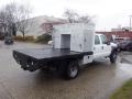 A 2009 Ford F-450 SD with a flatbed and an aluminum service body attached in the rear