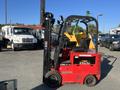 A red 2013 Raymond Forklift with a black lifting mast and operator's seat