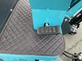 A 2024 AGT Mini Excavator pedal on a textured mat with a diamond pattern