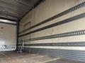 Interior of a 2008 Hino 268 truck featuring a metal reinforced wall with horizontal stripes and an empty cargo area