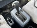 Gear shift of a 2006 Hino 268 with a black knob and a labeled gear selector panel
