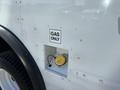 A white 2012 Ford Econoline with a gas fuel inlet located on its side featuring a yellow cap and a sign that reads GAS ONLY