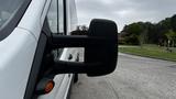 A 2017 Ford Transit van with a prominent side mirror view