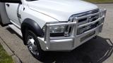 A 2014 RAM 5500 with a chrome front grille and bumper guard showcasing a white body and silver wheels