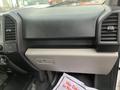 The interior dashboard of a 2017 Ford F-150 featuring a textured black panel with air vents and a glove compartment