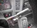 Interior view of a 2006 International 4300 with a gearshift lever and ignition keys in the foreground