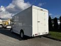 A white 2017 Freightliner M Line box truck viewed from the rear showing its tall cargo area and simple design