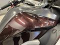 Close-up of a 2013 BMW K1600GTL motorcycle showing the glossy black and maroon finish of the bodywork and fuel tank