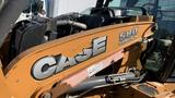 A 2015 Case 580 Super M backhoe loader with orange paint and large CASE lettering on the side