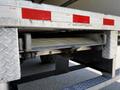 Close-up of a 2020 Hino 195 truck's rear step assembly showcasing the metallic construction and diamond plate texture