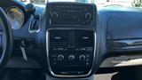 Interior dashboard of a 2016 Dodge Grand Caravan featuring the audio system and climate controls